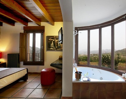 Foto del jacuzzi con vistas a la montaña que se encuentra en la Suite Junior con bañera de hidromasaje de regufugio rústico Hotel Alahuar.