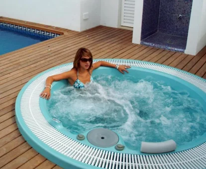 Foto de una mujer tomando un baño en el jacuzzi de los Apartamentos Ardales
