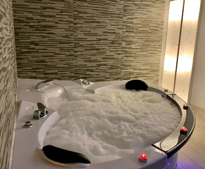 Foto de la bañera de hidromasaje con espuma del Duplex Usuaia con Jacuzzi 

