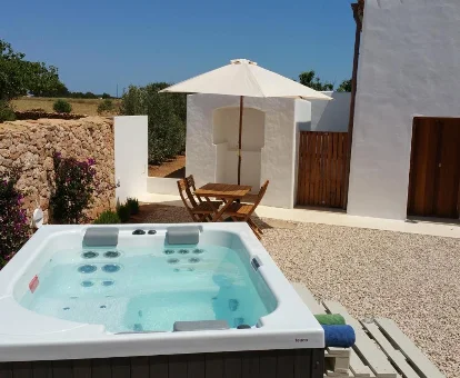 Foto del jacuzzi exterior para 3 personas que se encuentra en la Villa Can Vicent Puig 
