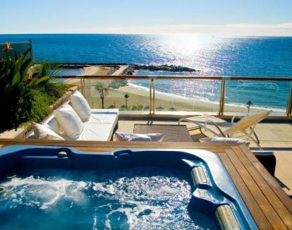 Foto de la Suite Junior Deluxe con jacuzzi privado en la terraza y vistas al mar.