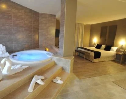 Foto de la amplia Suite con jacuzzi privado cerca de la cama.