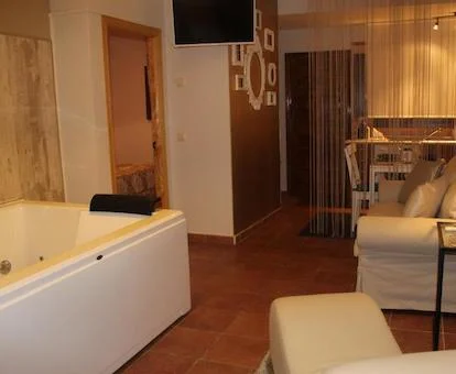 Foto del jacuzzi para dos personas con chorros de hidromasaje situado en el salón junto a la cocina y enfrente del sofá.