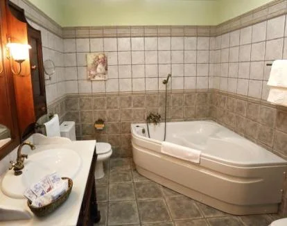 Foto de la habitación con cama extra grande y jacuzzi privado en el baño.