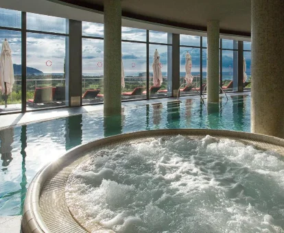 Foto de la piscina cubierta y el jacuzzi redondo que se encuentran en el hotel Dolce by Wyndham Sitges Barcelona