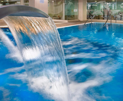 Foto de la piscina de interior con cascada de agua que se encuentra en el interior del hotel Eurosalou & Spa de Tarragona