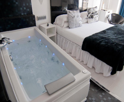 Foto de la habitación con bañera de hidromasaje al lado de la cama en el Hostal Santo Domingo