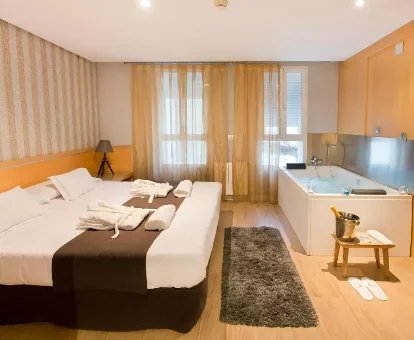 Foto de la habitación con bañera de hidromasaje al lado de la cama que se encuentra en el hotel YOU & CO. J. Botánico Boutique 

