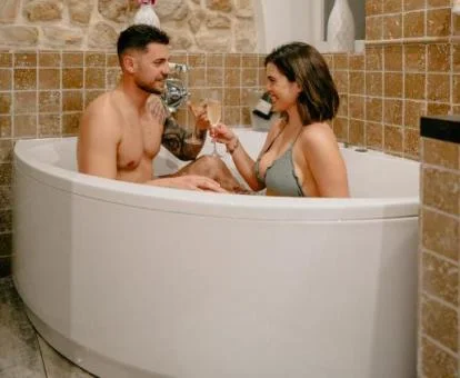 Pareja disfrutando del jacuzzi privado de la Habitación Doble Superior del hotel.