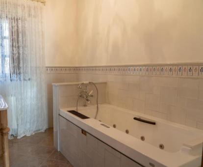 Amplia bañera de hidromasaje privada del apartamento de dos niveles de este establecimiento rural.