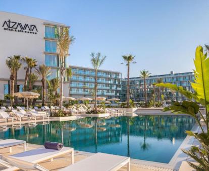 Moderno edificio de este hotel con encanto con gran piscina rodeada de tumbonas.