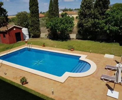 Zona exterior con piscina y amplios jardines de este hotel con encanto.