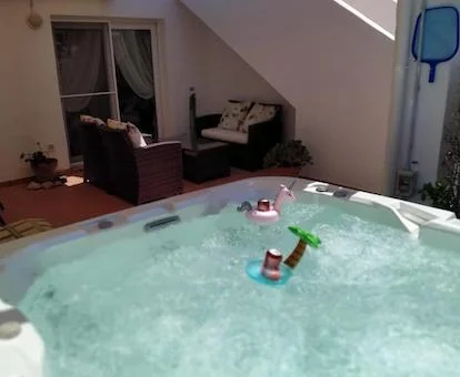 Jacuzz i de gran tamaño en la terraza del apartamento y funcionando y con los chorros de burbujas en funcionamiento