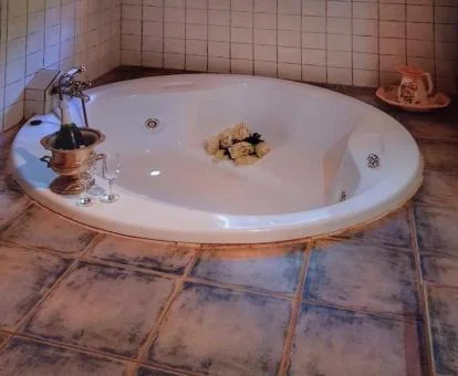 Amplio jacuzzi circular de la casa con cama doble del establecimiento.