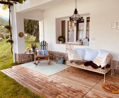 Acogedora zona exterior con mobiliario rodeado de jardín de este bed and breakfast.