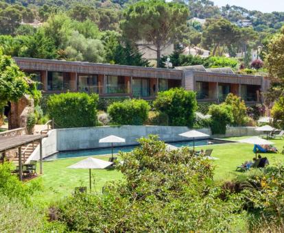 Edificio de este hotel con encanto rodeado de naturaleza con piscina al aire libre.