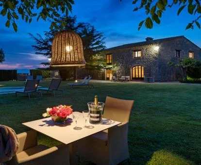 Zona exterior ajardinada con piscina y comedores de este hotel con encanto.